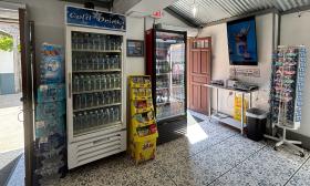 Fridges packed with beverages sit near the door entrances of the shop