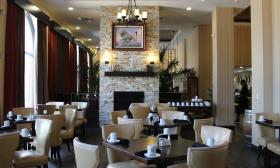 The Oakroom at DoubleTree by Hilton has a fireplace, comfortable chairs, and a full bar
