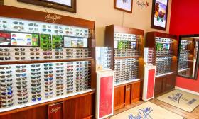 The wall of designer sunglasses inside the Rainbow Shades store