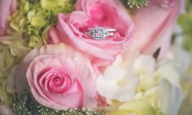 Glittering wedding ring nestled in a pink rose