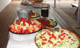A food spread displayed by the restaurant's catering service