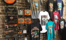 Graphic t-shirts hanging on a wall display