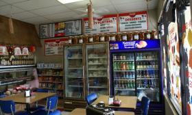 The inside of the shop has soft drinks, Italian groceries, and subs available