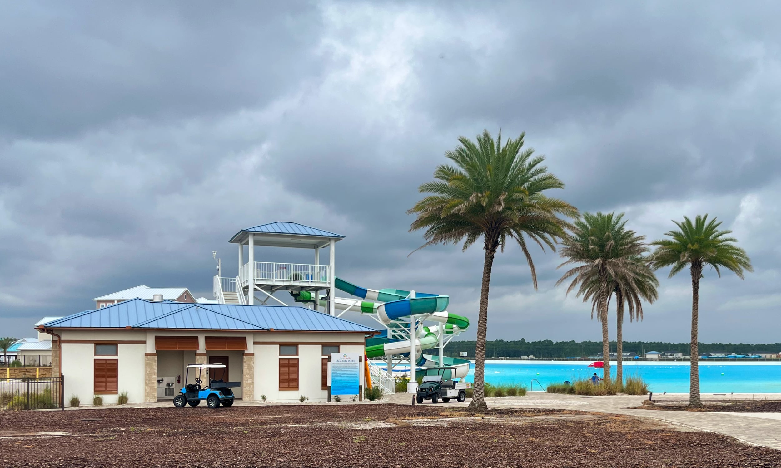 A view of the crystal lagoon and waterslide in Beachwalk.