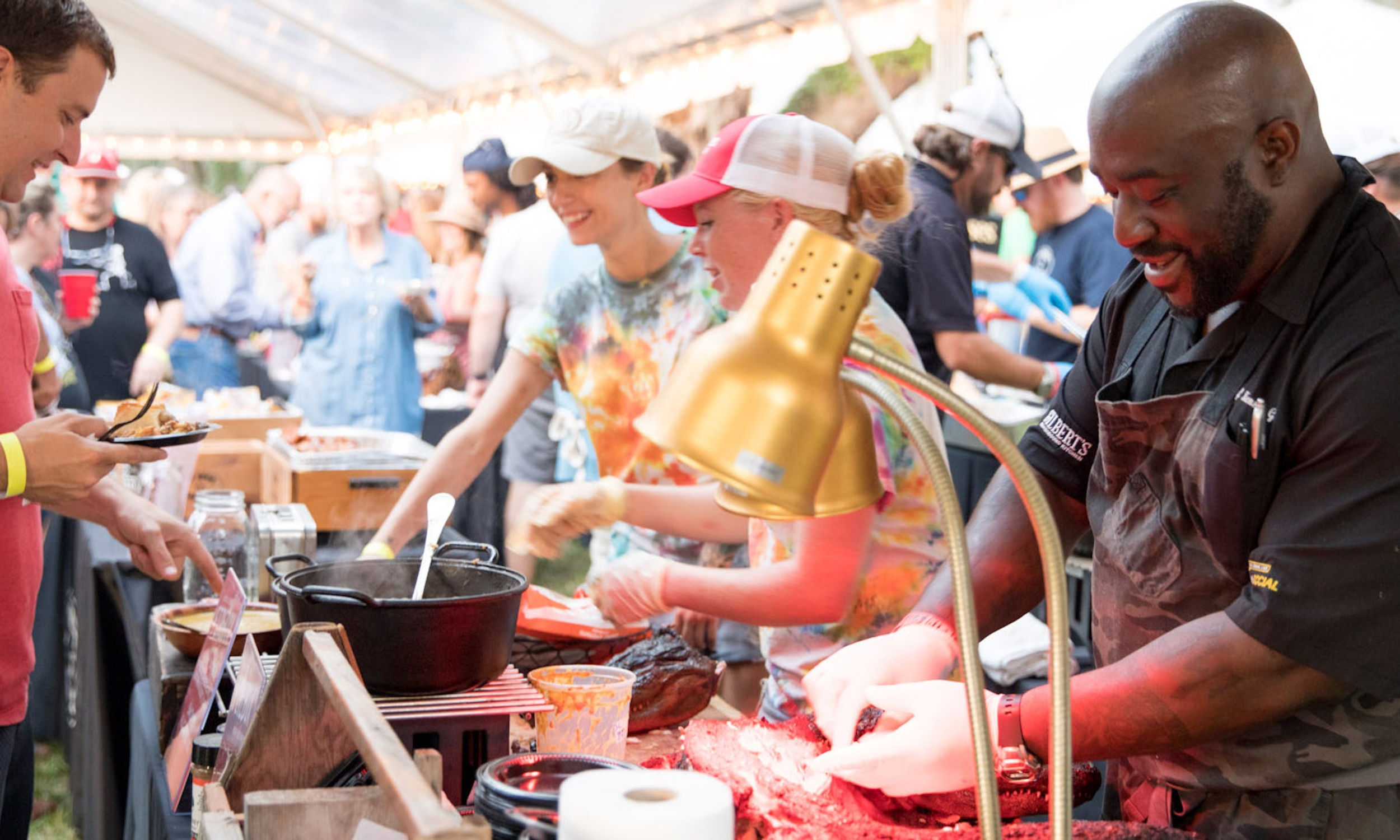 A chef serving roasted pig at a food event