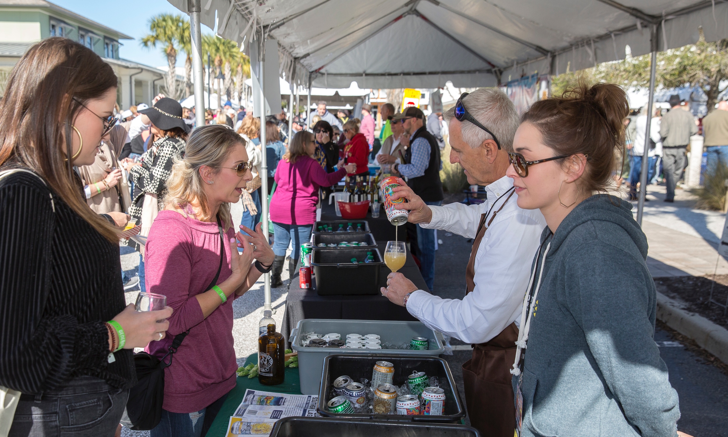 Women and guests outdoors at a food and beverage event