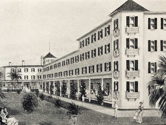 A black and white drawing of a large hotel in St. Augustine, Florida. It is a four story building of massive size, with spores on its corners and many windows facing a grand lawn filled with tropical plants and little drawn tourists in their light colored clothes. 