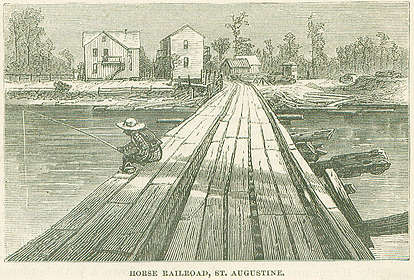 A black and white print of a "horse railroad" in St. Augustine, Florida. The road is made of large slates of wood and leads to another shore with a few small buildings, pine trees, and logs. The figure of a fisherman sits on the edge of the road, dangling his fishing line into the water. 