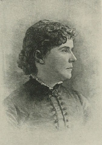 A black and white lithograph image of a woman's profile. She has dark curly hair that is pulled into a low bun. She wears dark clothes from late 1800s. She is forlorn in the eyes with a downturned mouth.