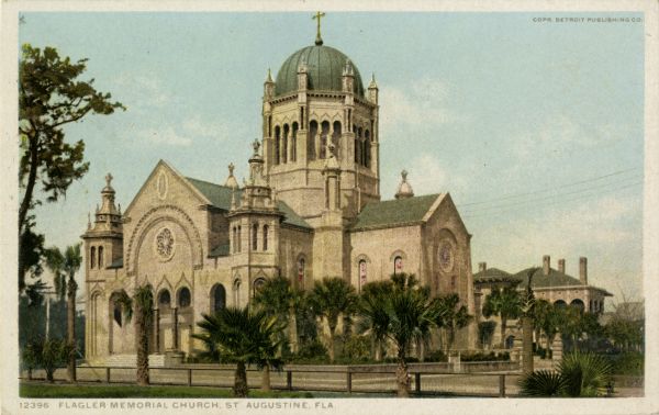 A colored print of the Memorial Presbyterian Church in St. Augustine, Florida. It is an opulent stone church with unique architectural layout and beautiful features, the main one being a large copper dome. Palm trees on the street.