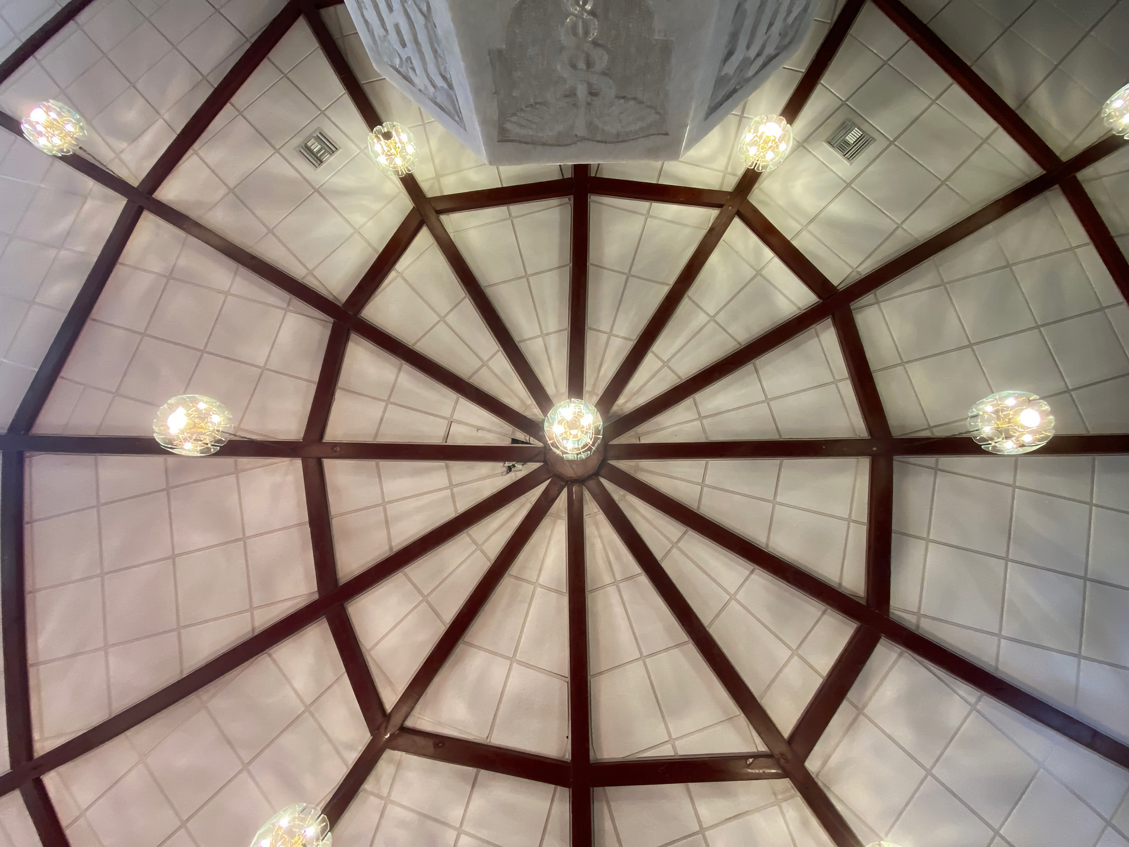 The ceiling of the St. Paul AME Church in St. Augustine. All white with dark wood beams in the shape of wheel spokes.