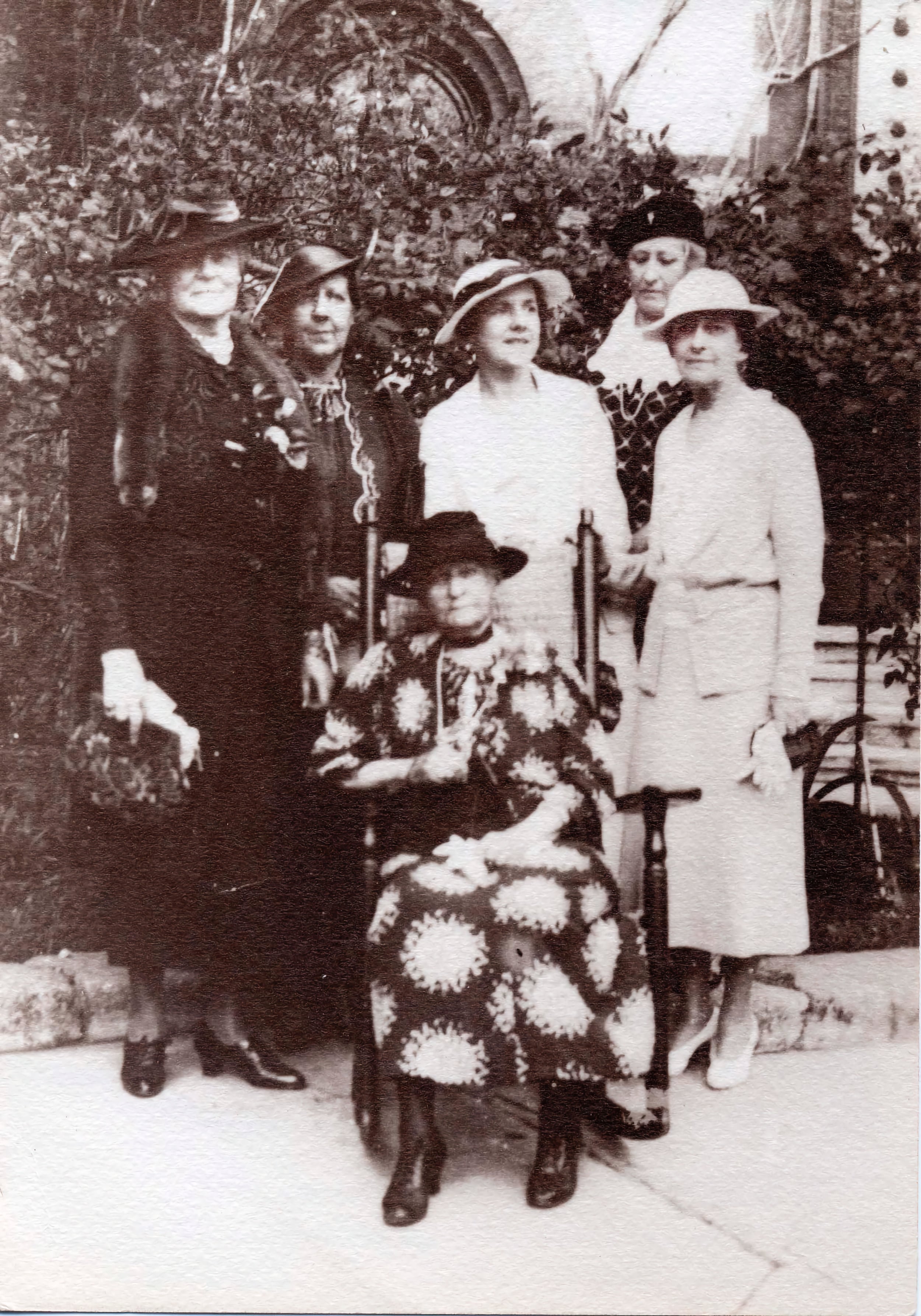A group of affluent white ladies ranging from middle aged to elderly in the courtyard of the Hotel Ponce de Leon in St. Augustine, Florida