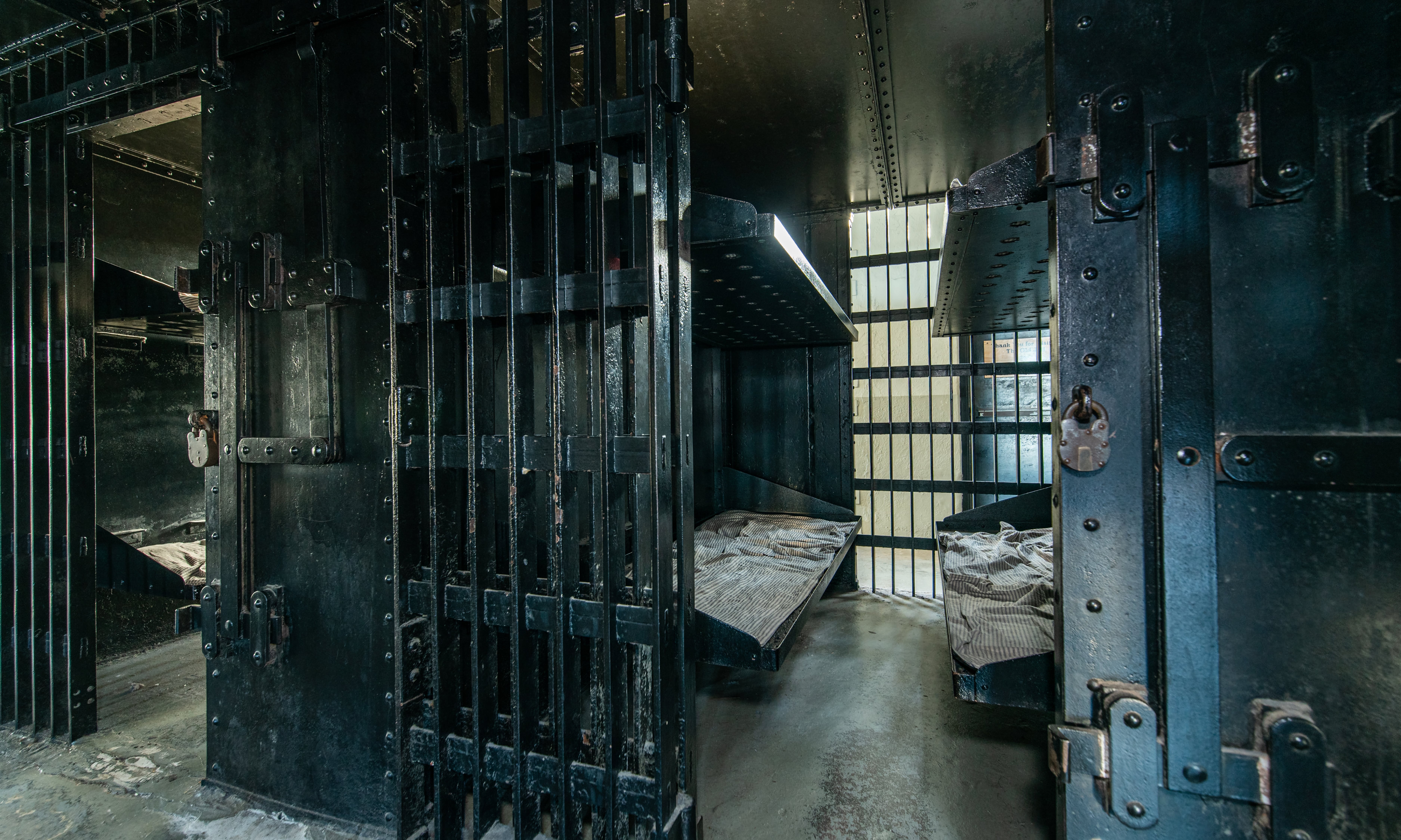 Cramped metal cells in the St. Augustine Old Jail show harsh conditions and cold interiors