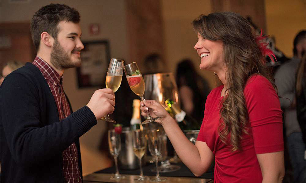 A young couple toasting with sparkling wine at the San Sebastián Winery in St. Augustine
