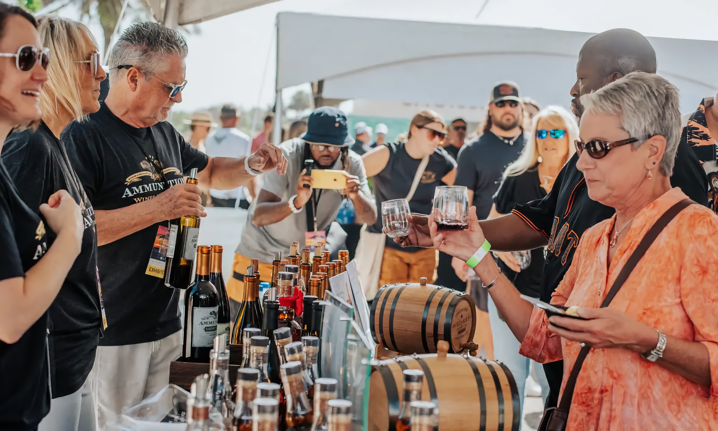 Vinters pouring wine for people attending a food and wine tasting festival in Vilano Beach