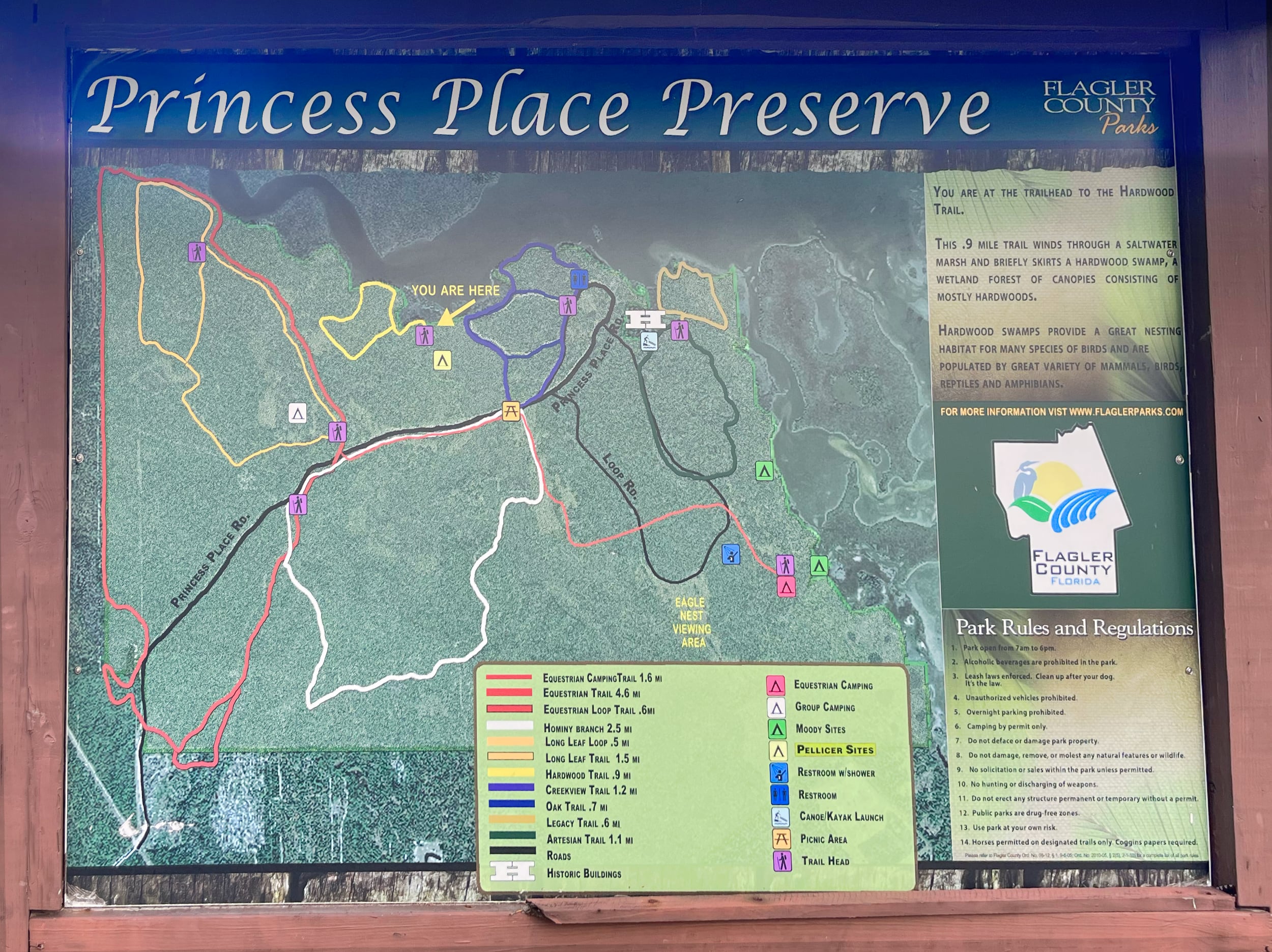 A sign showing the color coded trail system at Princess Place Preserve. 