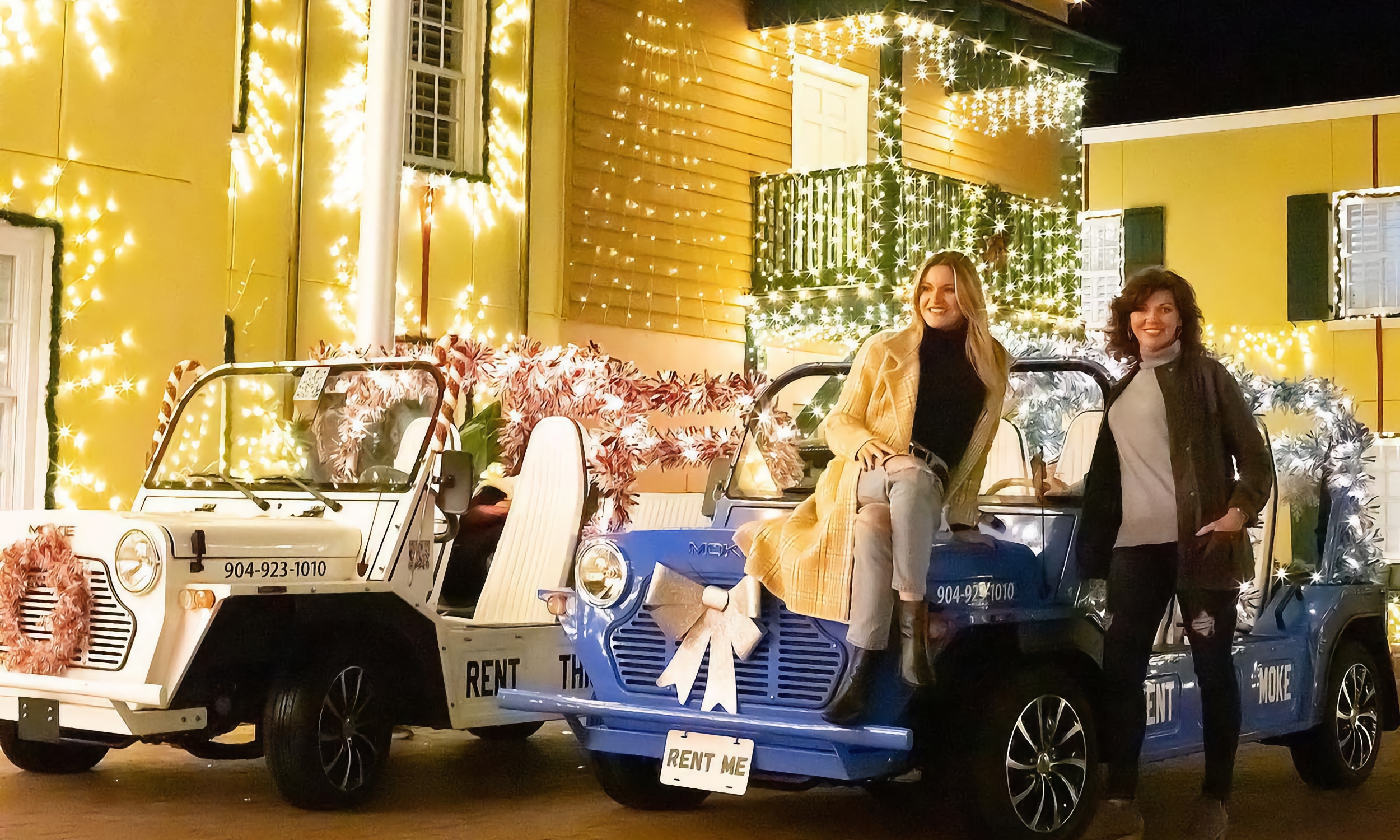 Two women with two MOKE electric vehicles enjoying Nights of LIghts