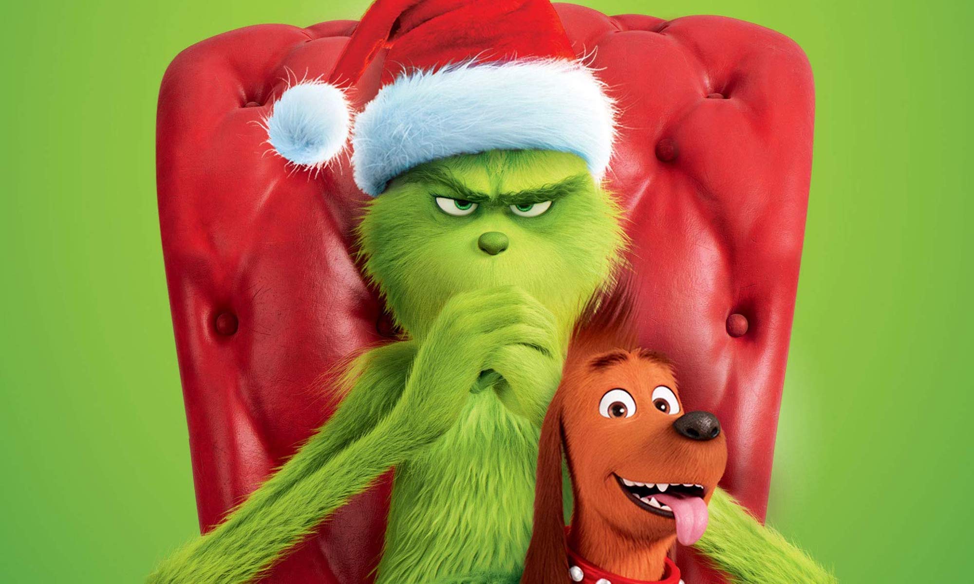 Grinch on a red chair with his brown dog