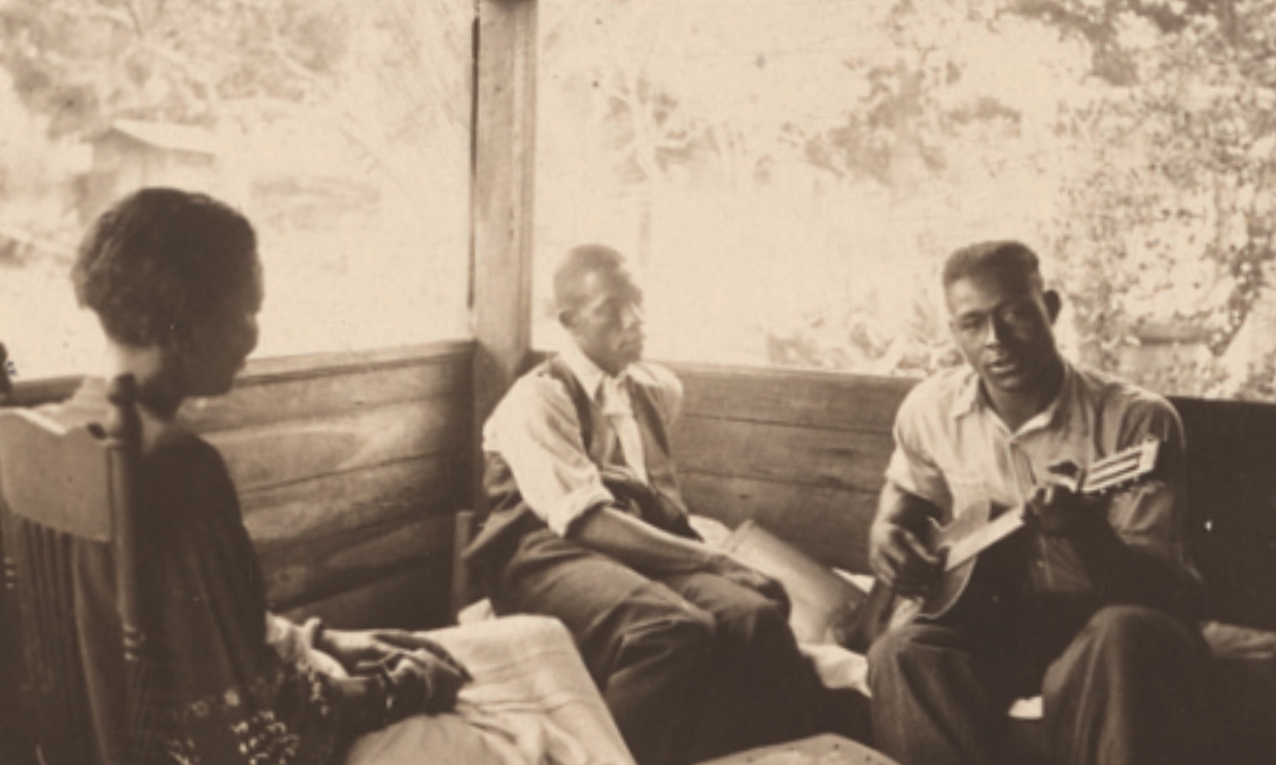 Zora Neale Hurston, Rochelle French, and Gabriel Brown lounging on the porch in Eatonville in 1935