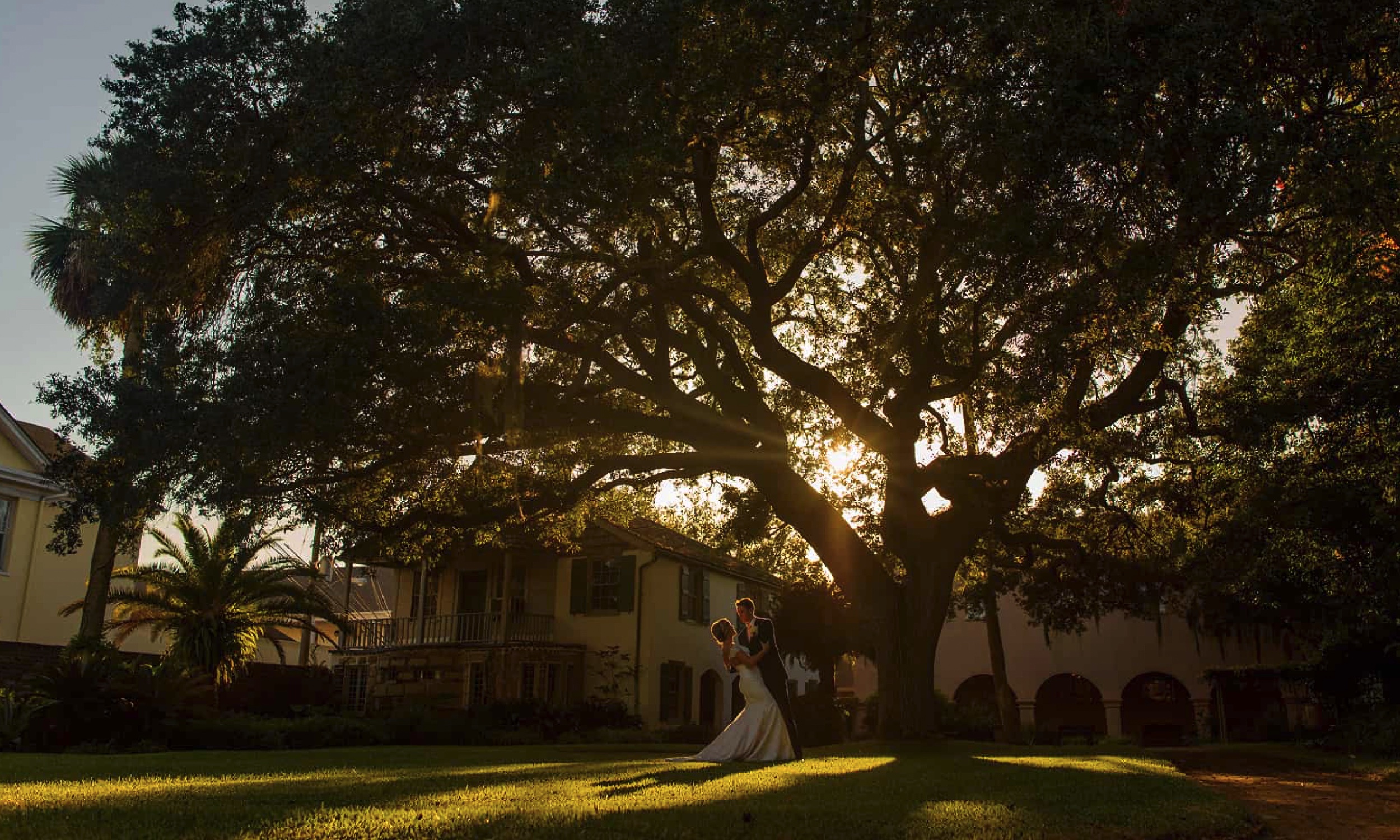 A bride and groom on the lawn of the Oldest House Museum