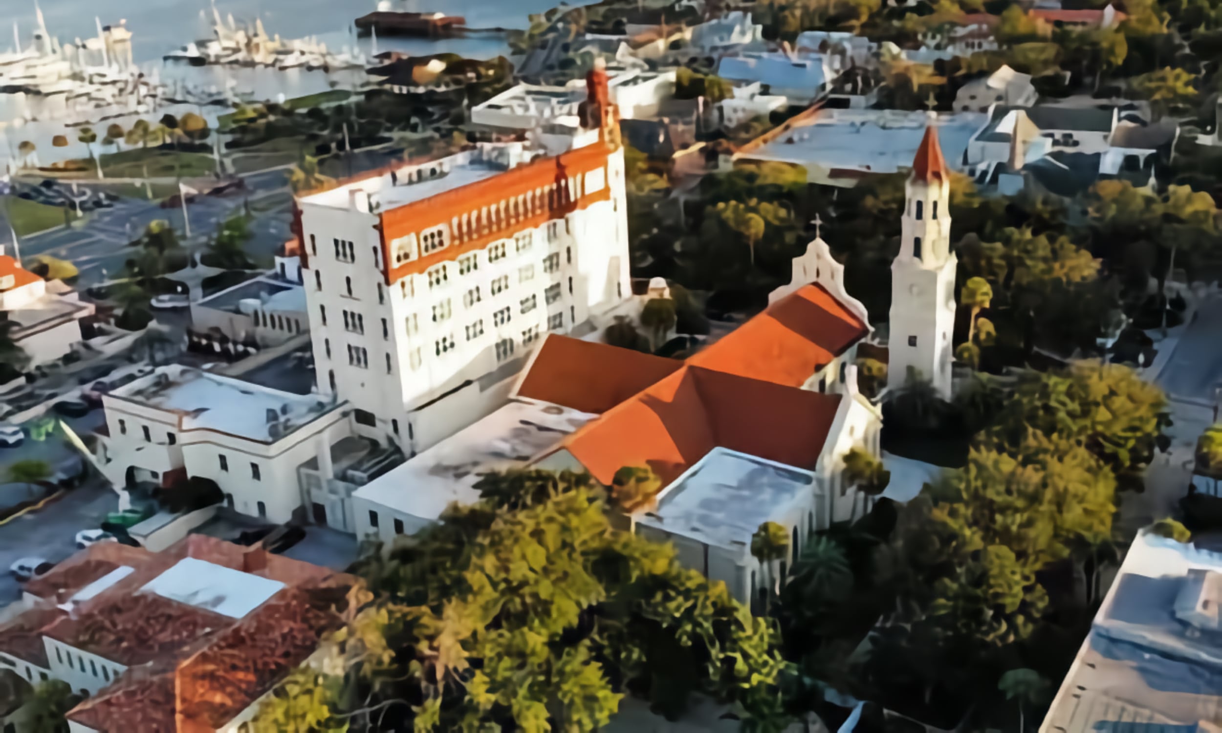 Aerial view of Trinity Parish and surrounding area with distinctive red-roofed buildings and nearby marina
