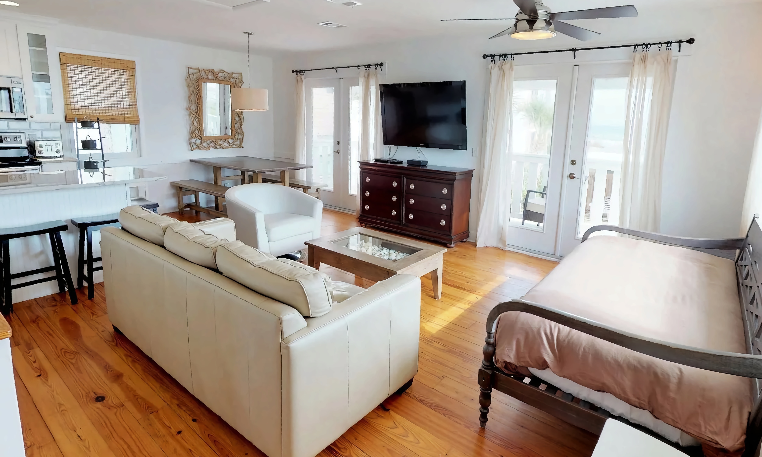 The great room at Linda's Beach House Cottage 2 with a kitchen and living area overlooking the deck on the ocean