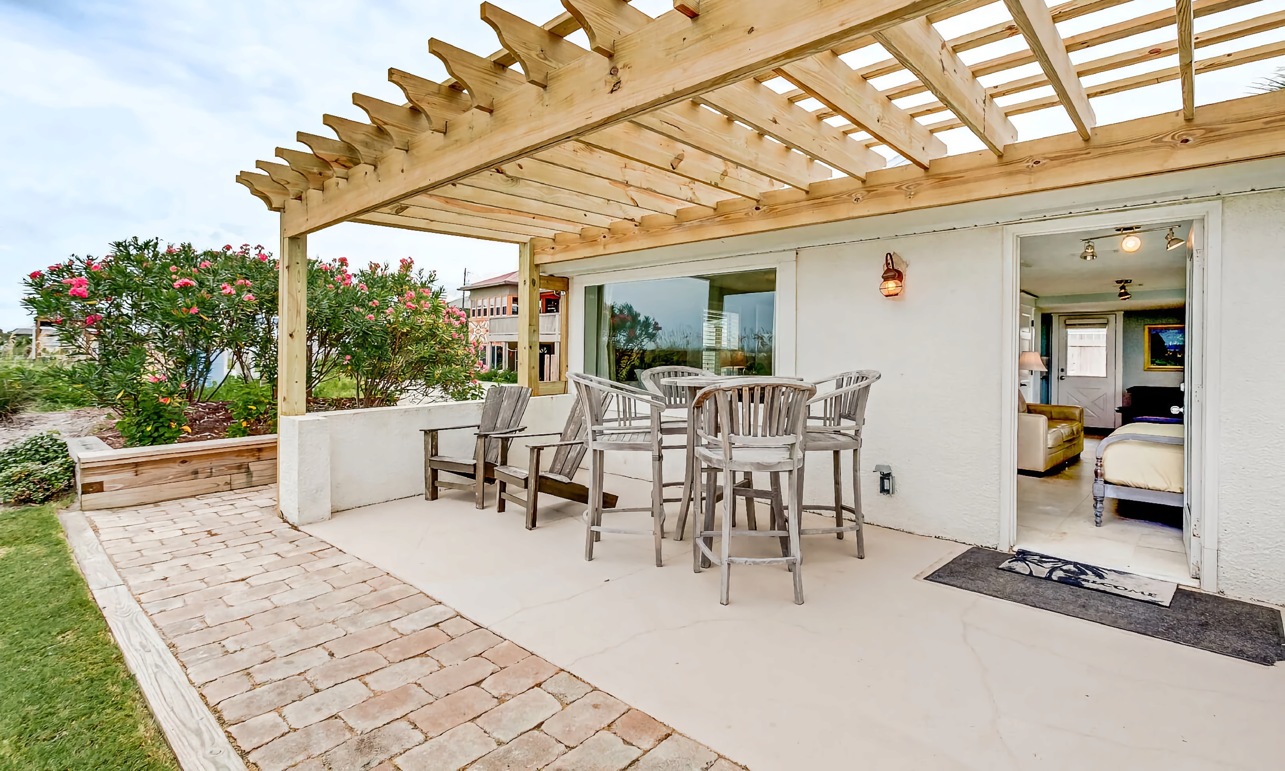The patio deck, is covered with a wood pergola, and has multiple seating areas