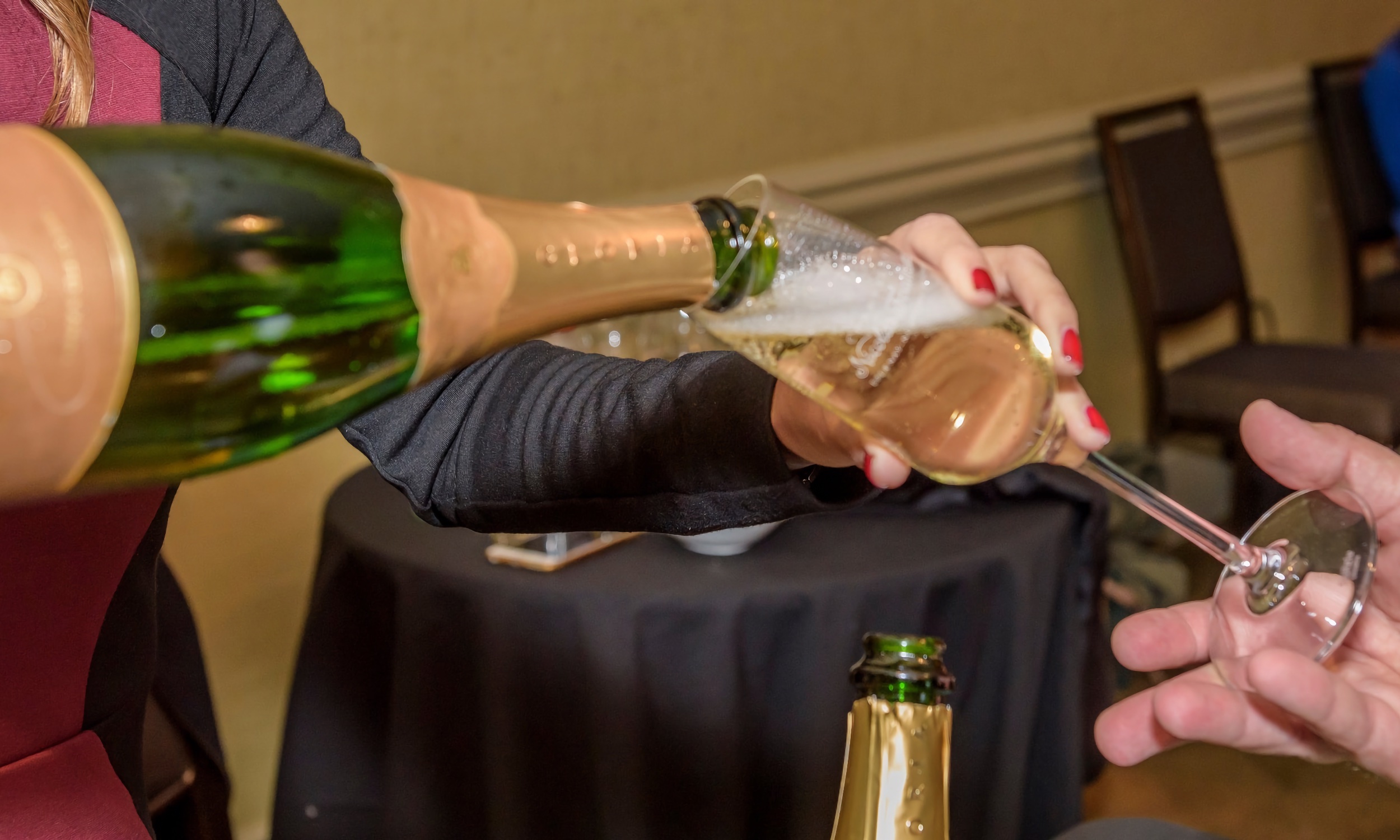 A person pouring champagne at the St. Augustine Food + Wine Festival