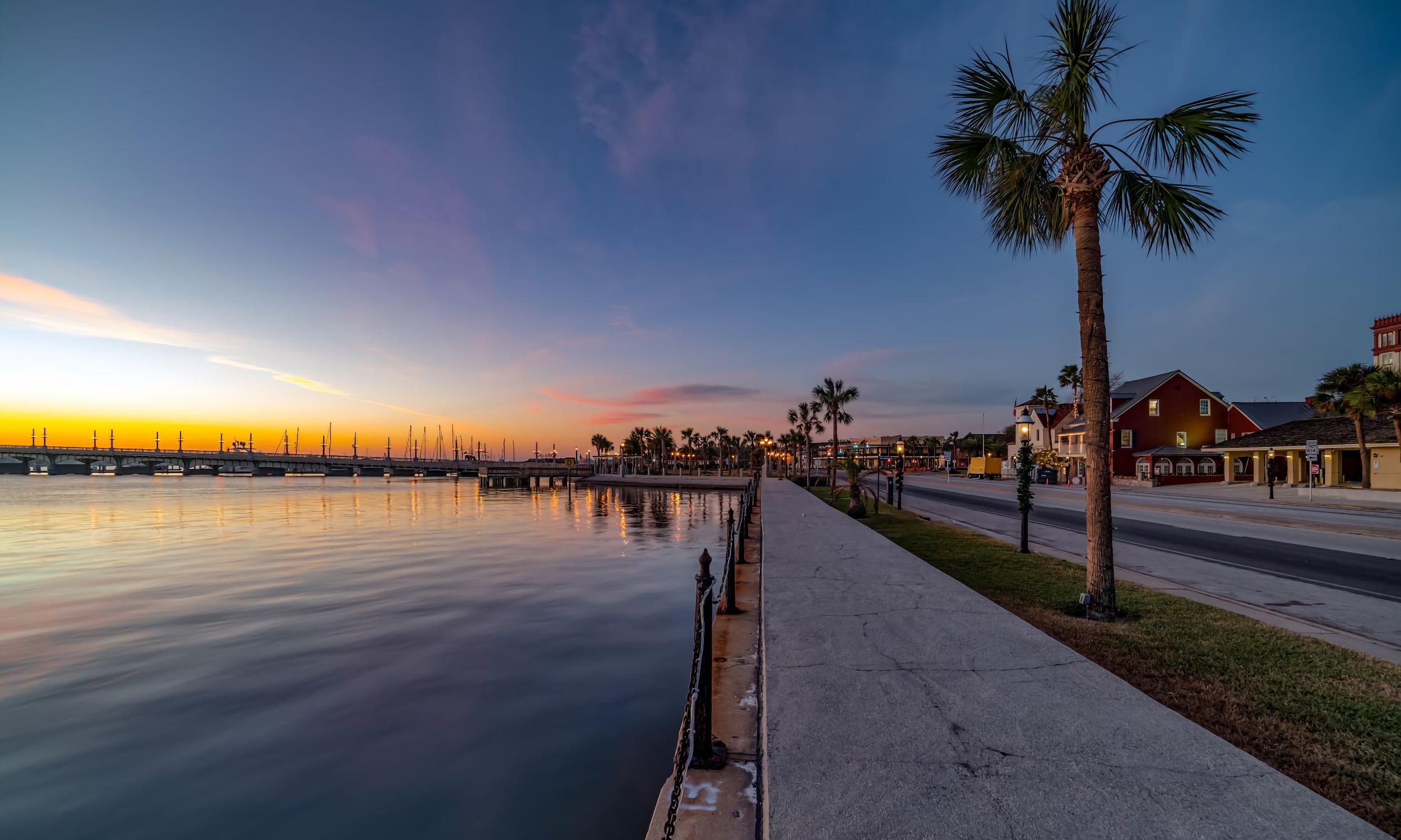 Sunset casts warm hues over the calm waters of the bayfront