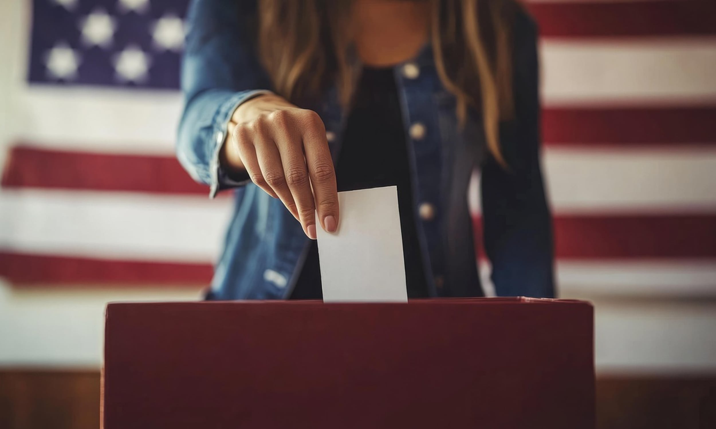 voter casting a ballot in front of an American flag
