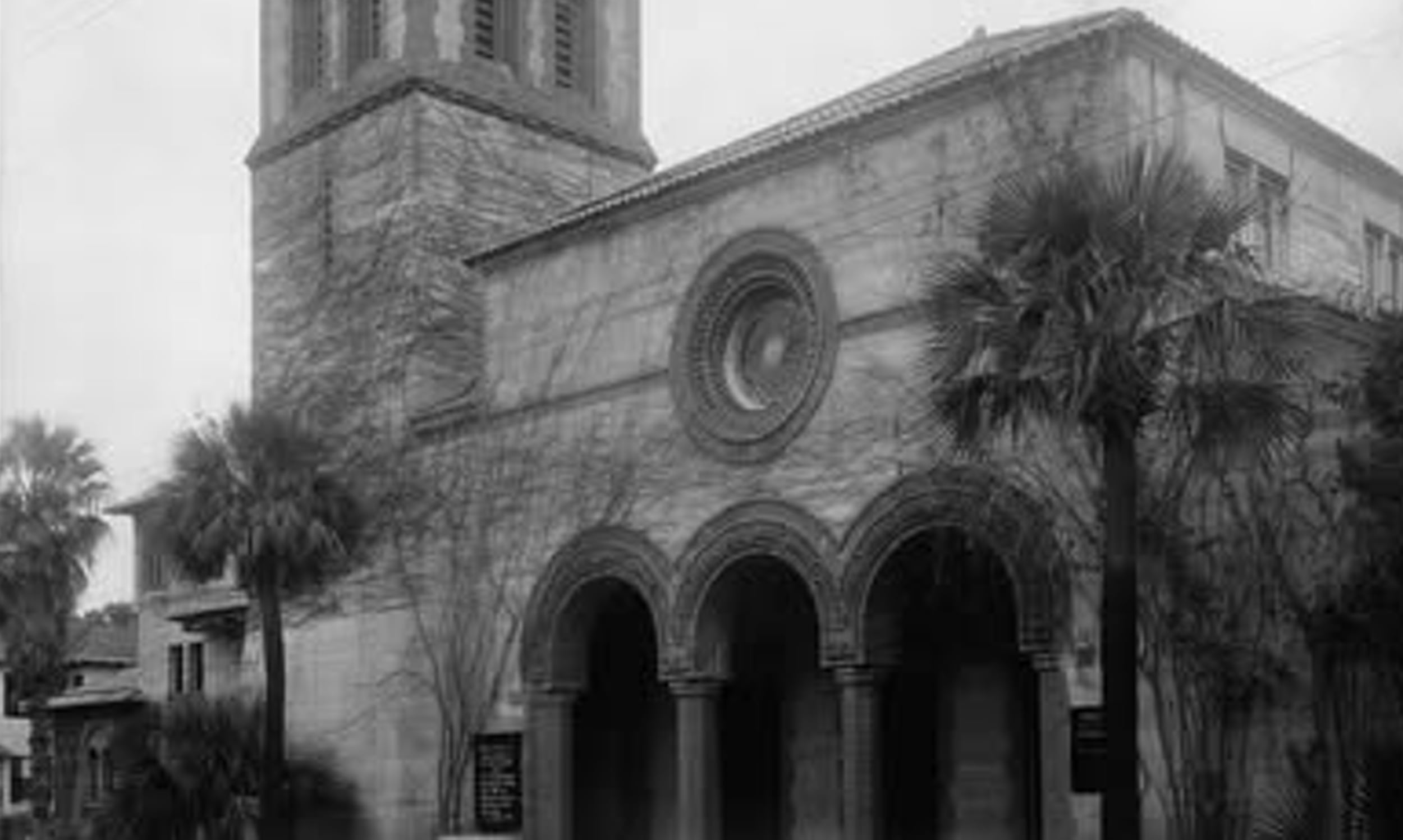 Black and white photograph of Grace United Methodist Church and surrounding palm trees