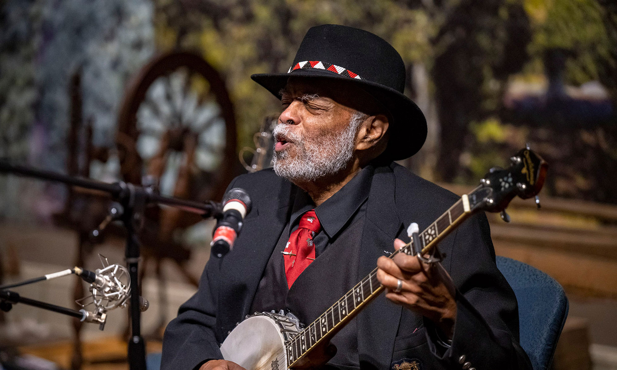 Activist Sparky Rucker playing his guitar outside.
