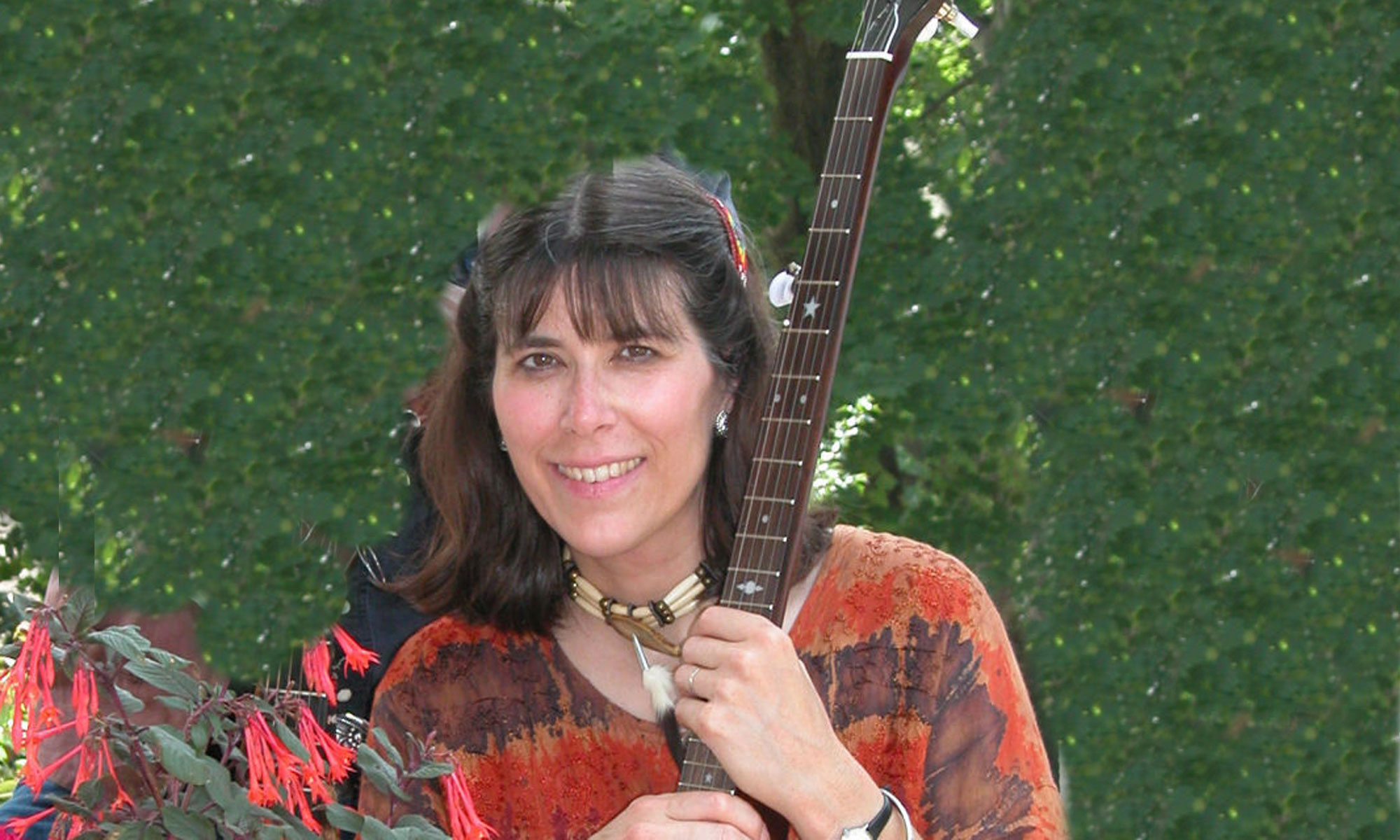 Rhonda Rucker with her guitar, outside