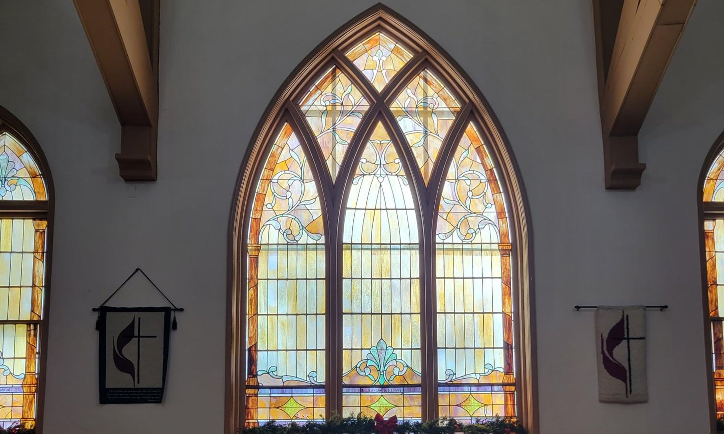 Stained glass window and flag display at First United Methodist Church in St. Augustine