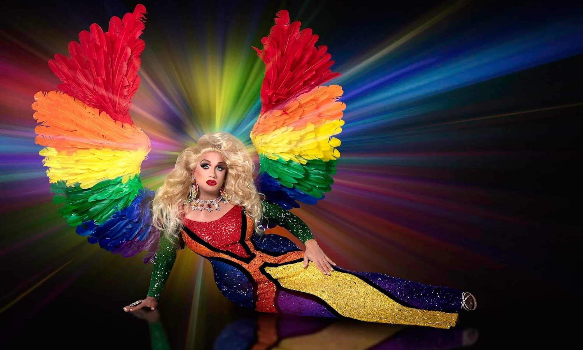 A drag queen in a rainbow outfit