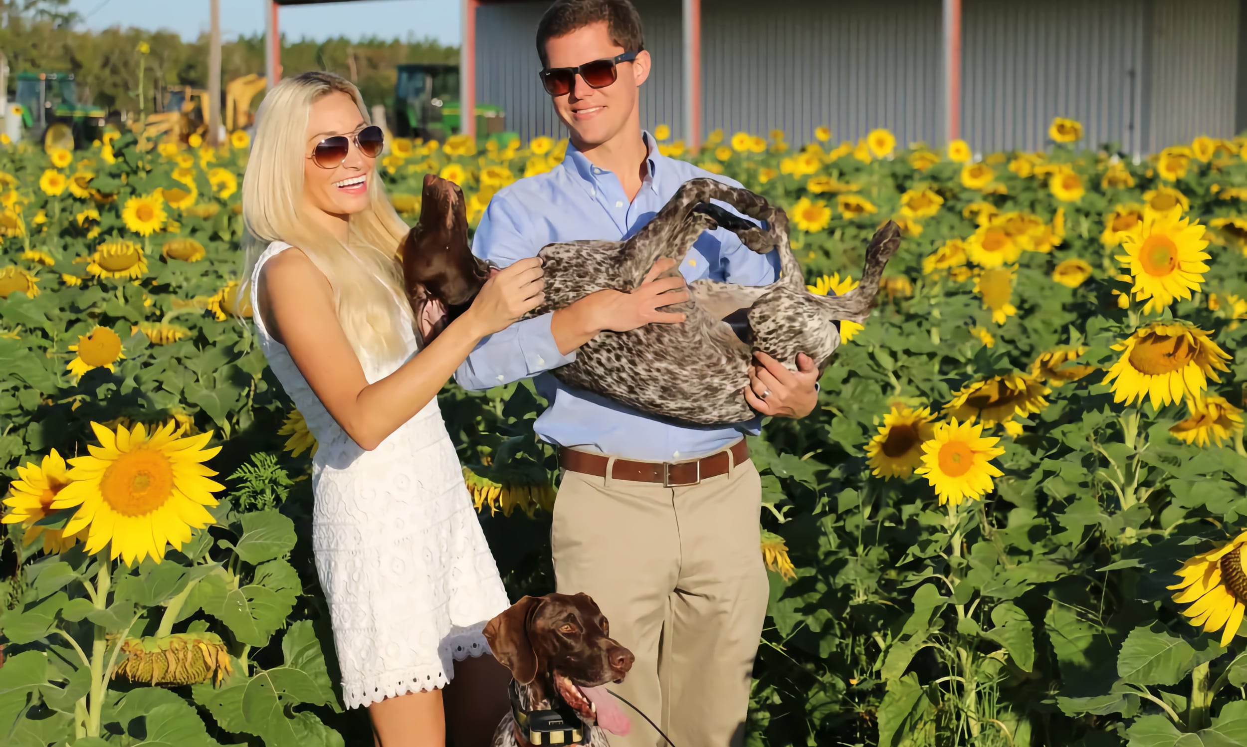 A man and woman with their two dogs at Parker Flower Farms