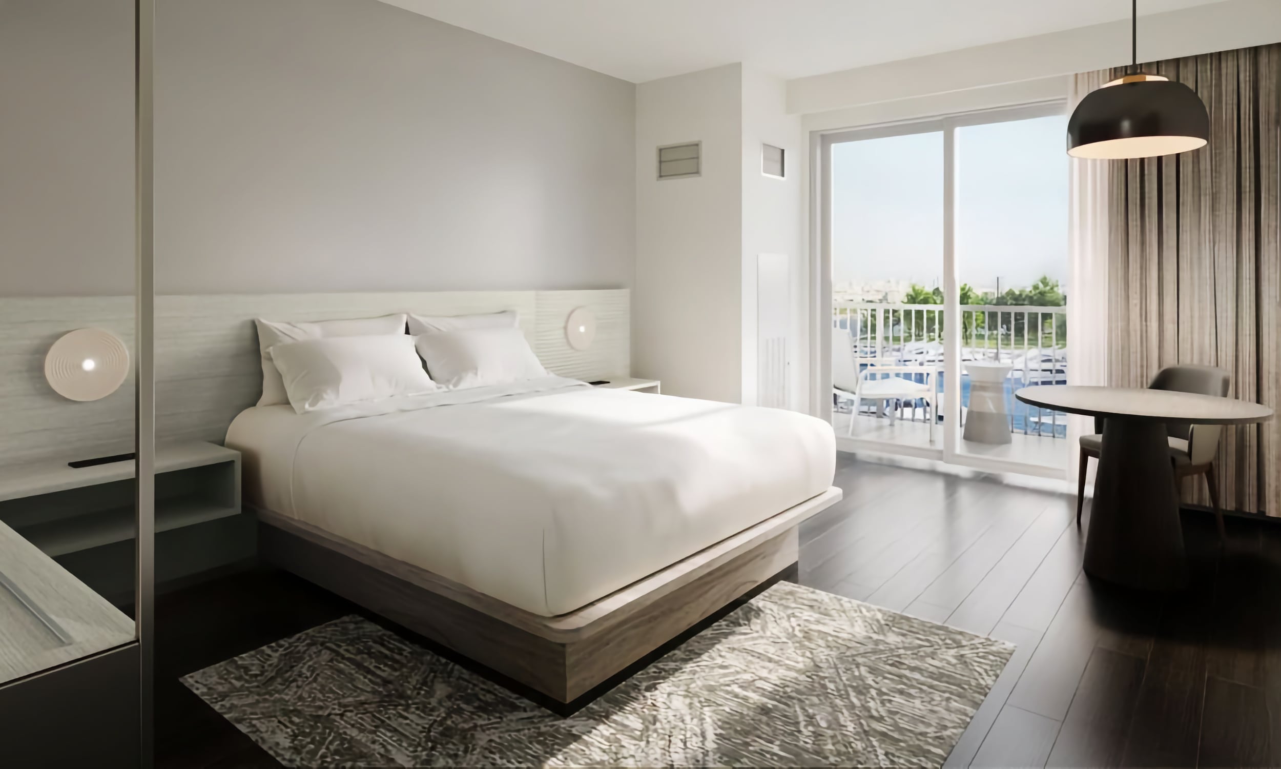 A king room with a balcony and view of the pool at AC Hotel in St. Augustine