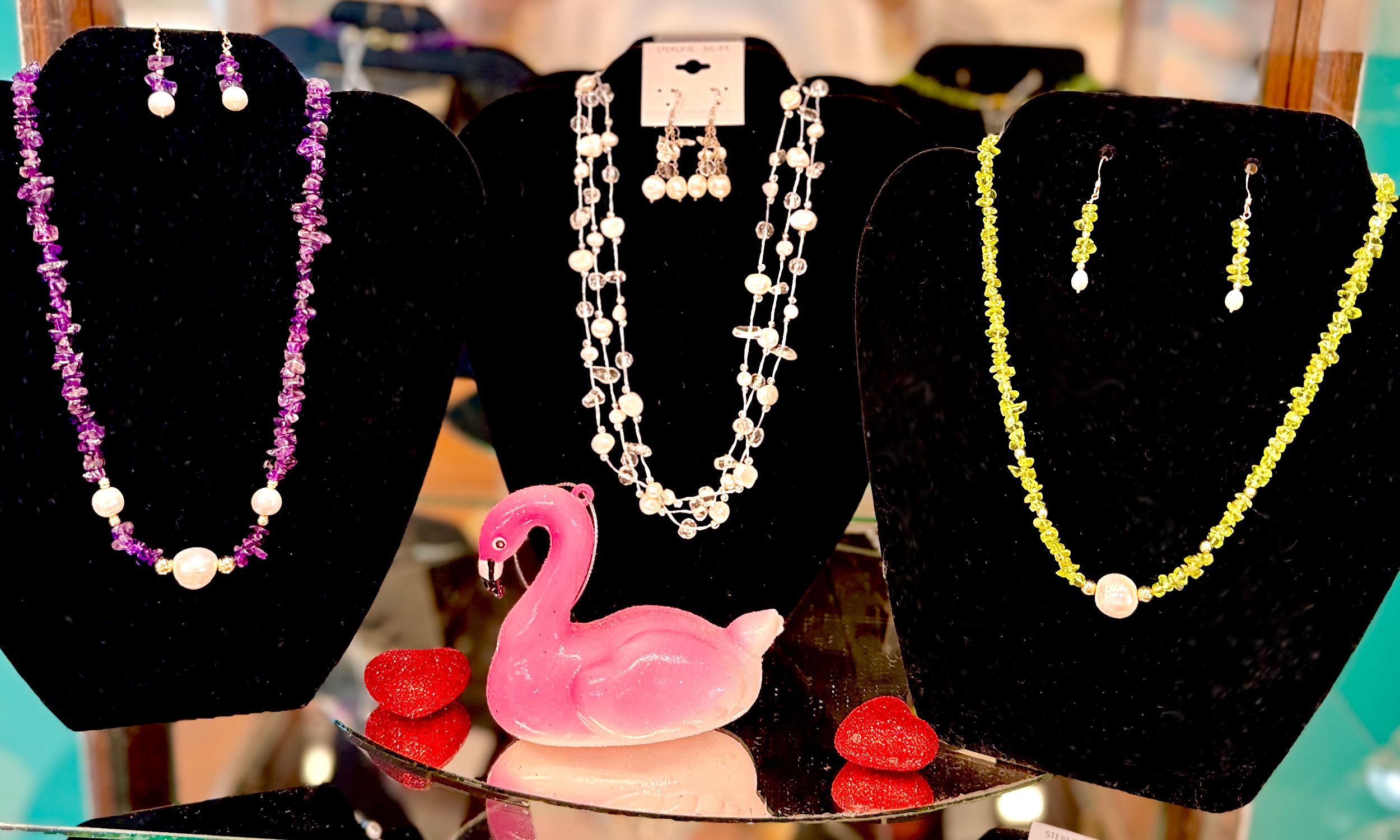 Three sets of earrings and necklaces created with pearls and other stones