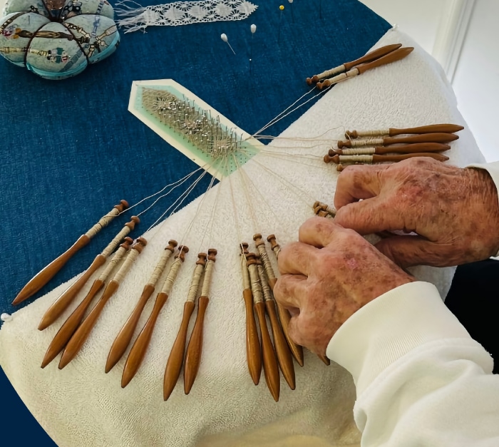 A nun, making bobbin lace at Father O'Reilly House
