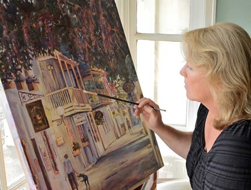 Artist Martha Ferguson painting at an easel