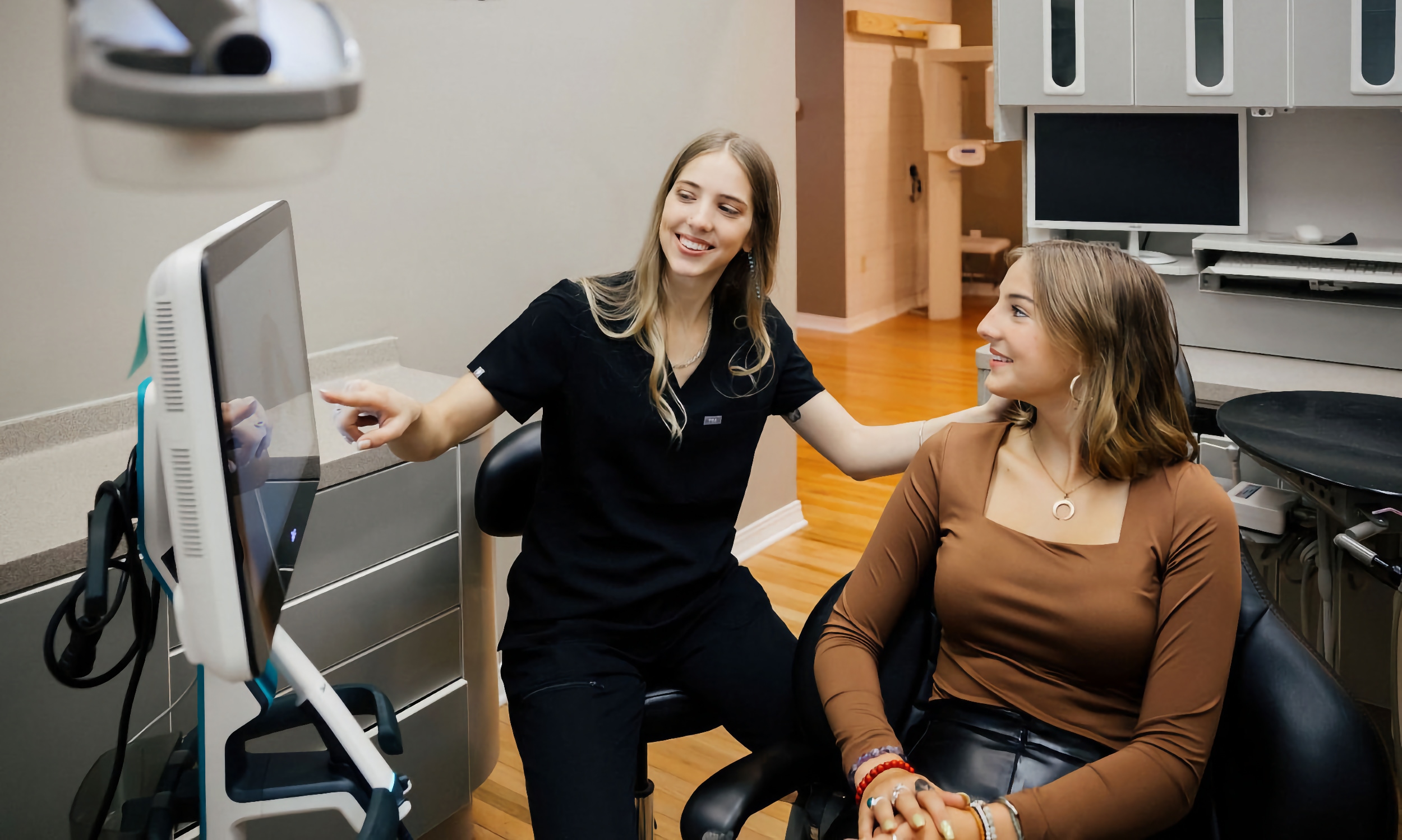 The hygienist talking with a dental patient