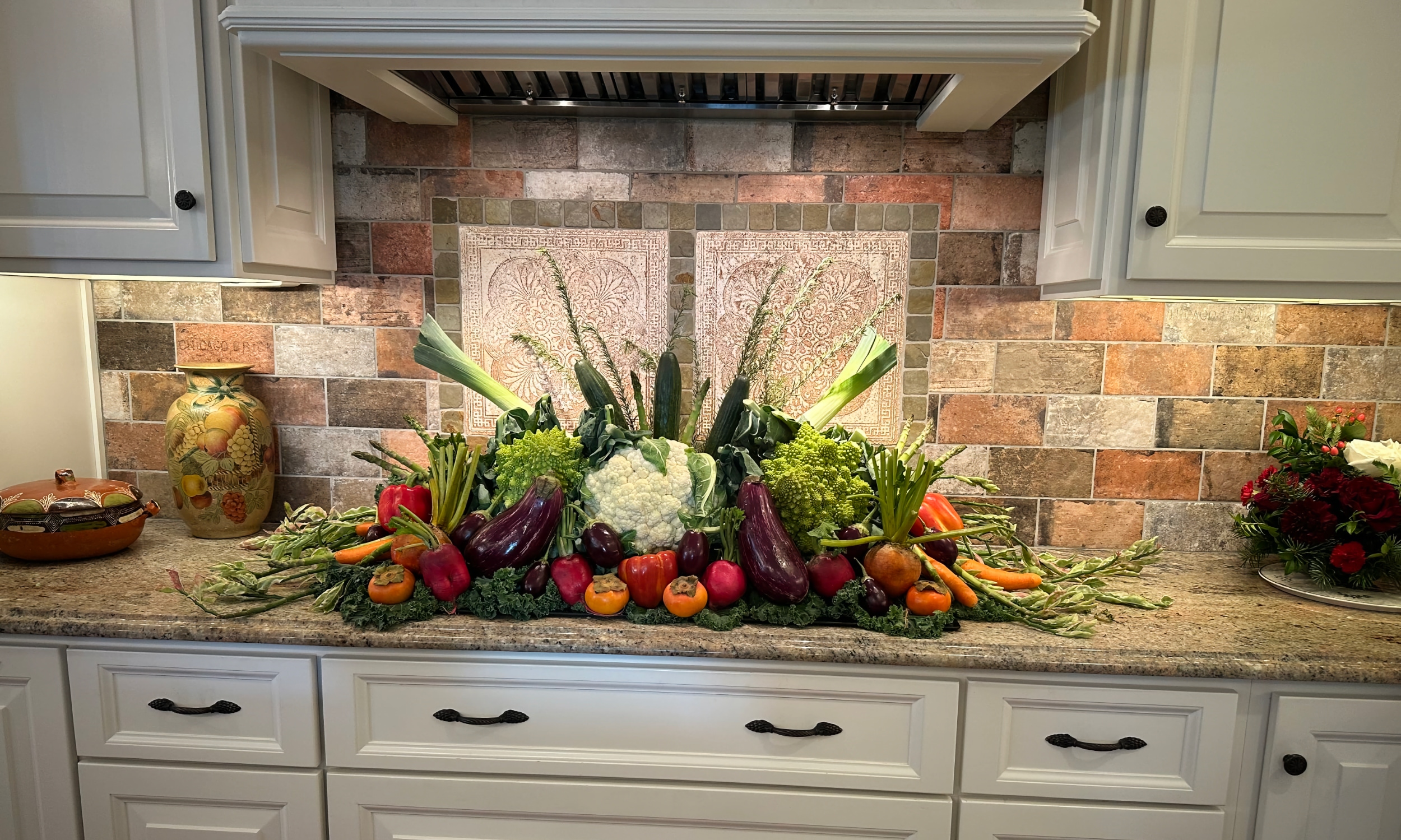 This large arrangement of fresh vegetables sits on a kitchen coutner during the 2026 Holiday Tour of Homes 