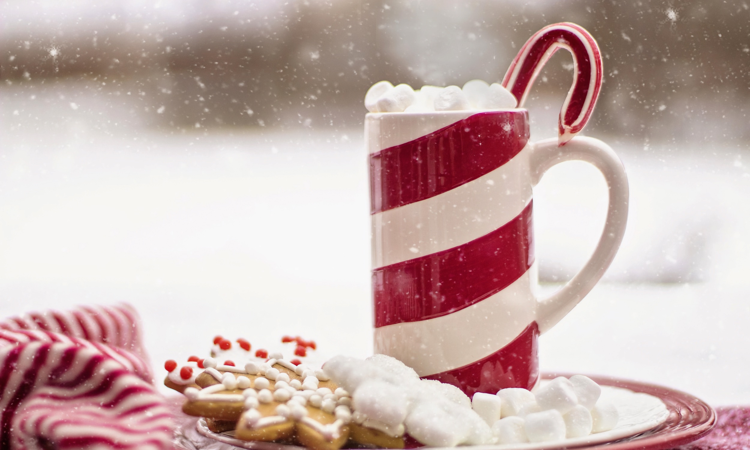 A candy cane placed in a hot beverage