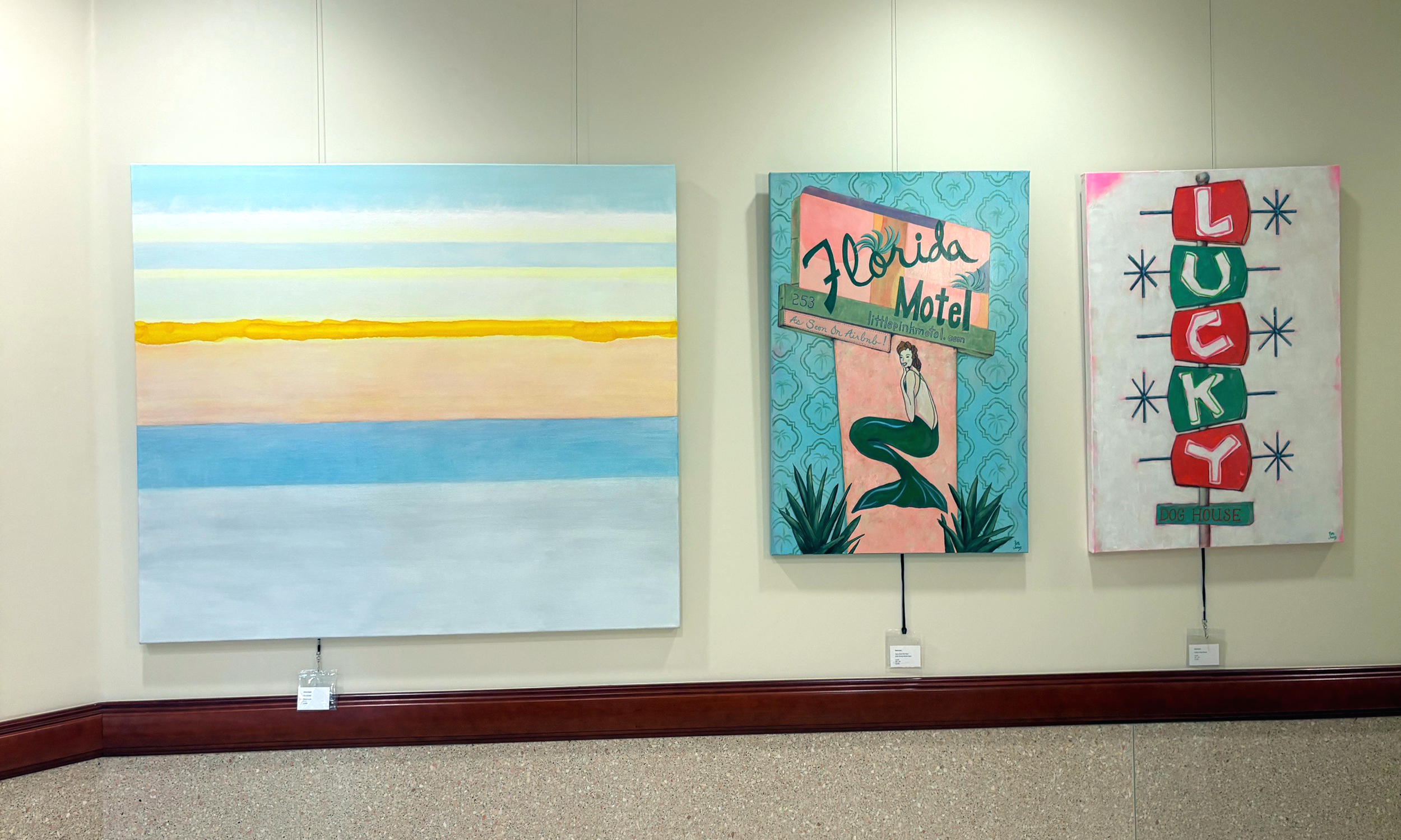 Three works of art on a gallery wall