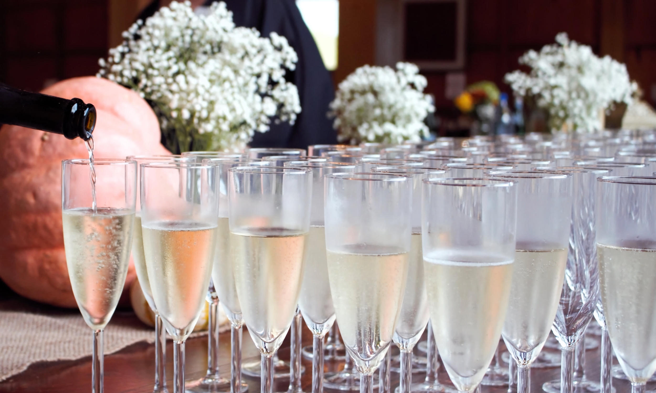Glasses of Champagne being filled for a gala event