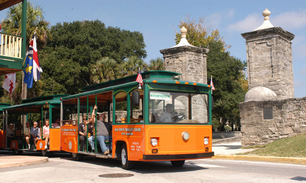 The Old Town Trolley, here at the City Gate, is both a tour service and a mode of transportation in St. Augustine.