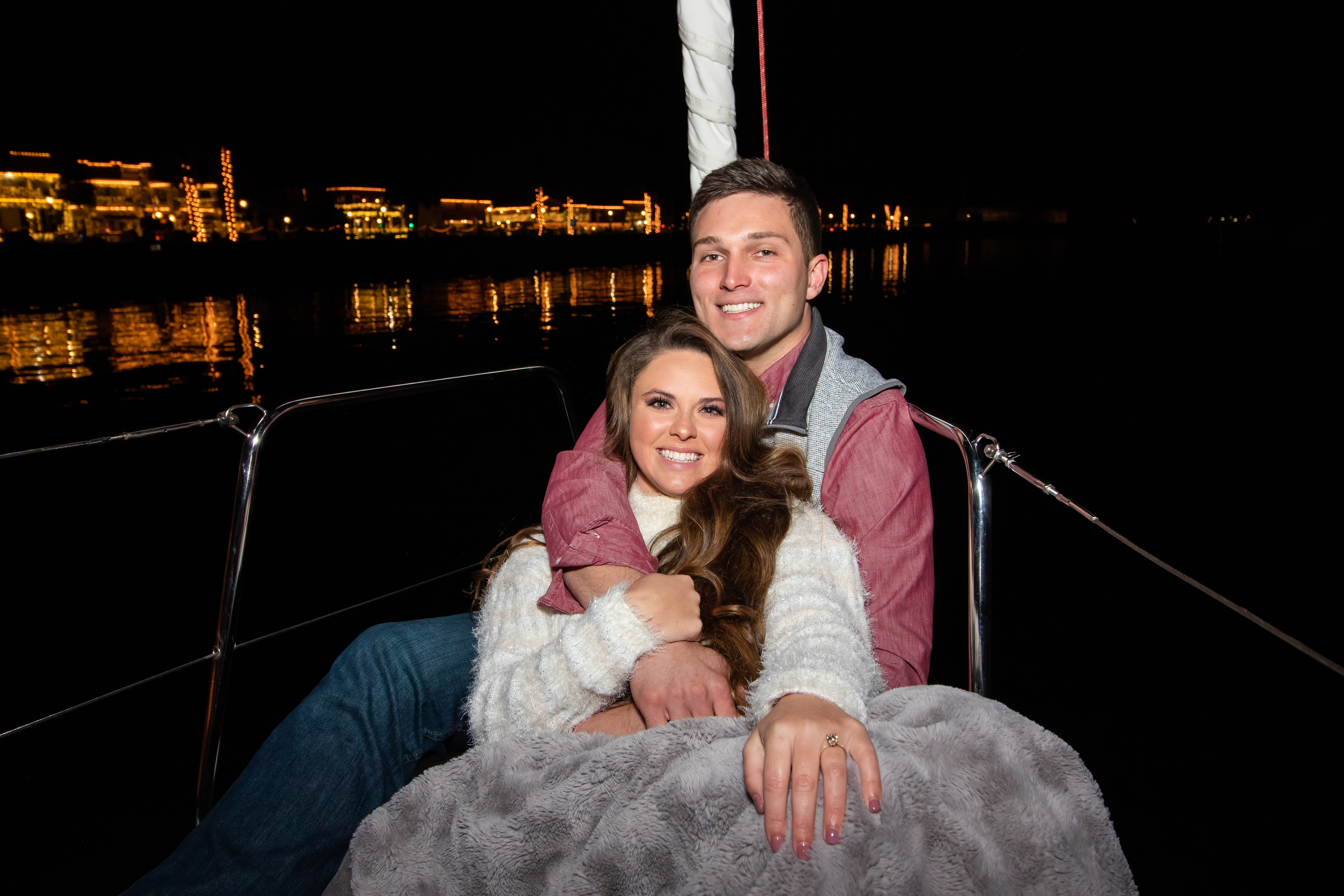 A couple enjoying a private Nights of Lights cruise aboard a sailboat from St. Augustine Sailing.