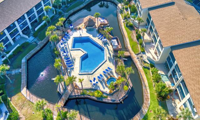 A drone view of the pool and water feature at a resort at 850 A1A on Anastasia Island