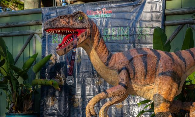 A statue of a raptor, holding a running medal in his teeth at the St. Augustine Alligator Farm