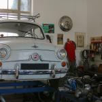 A white antique Neckar-Fagst on a lift in a garage